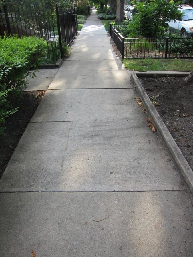 Residential concrete sidewalk in front of homes